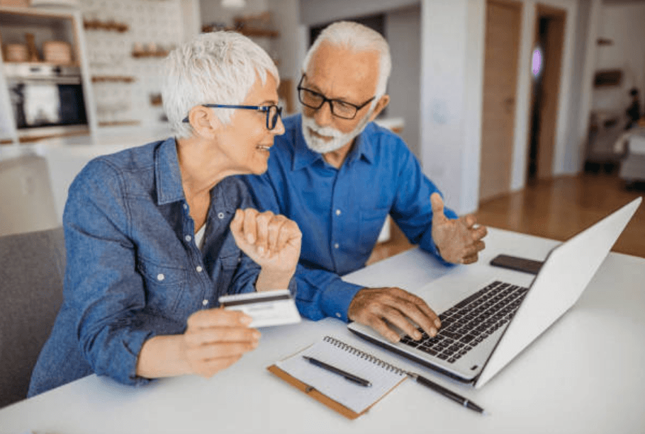 A couple reviewing their finances together at a laptop